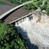 Building swept into Blue Earth River as Rapidan Dam suffers partial failure.