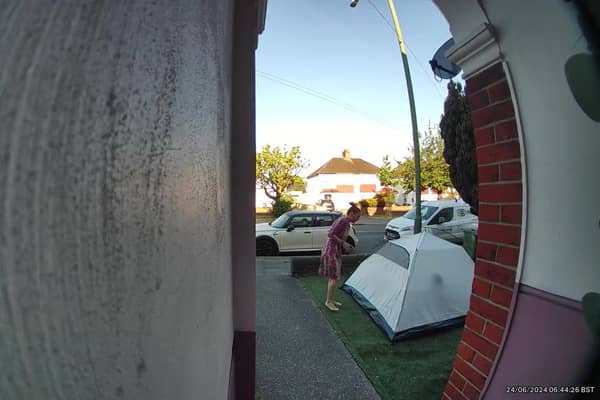 Video grab of the moment a mum was baffled when she looked outside and found a stranger had pitched a tent in her front garden overnight